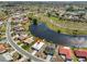Wide aerial shot of a waterfront home, showcasing its proximity to a golf course and nearby neighborhood at 1806 Wolf Laurel Dr, Sun City Center, FL 33573