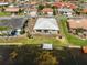 Waterfront home featuring a dock, lush lawn, and a well-maintained exterior, perfect for lakeside living at 1806 Wolf Laurel Dr, Sun City Center, FL 33573