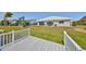 Expansive backyard featuring a private dock, large windows, and lush greenery at 1806 Wolf Laurel Dr, Sun City Center, FL 33573