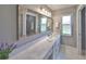 Elegant bathroom features dual sinks with marble countertops and a large mirror at 1806 Wolf Laurel Dr, Sun City Center, FL 33573