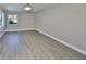 Bright, empty bedroom with wood-look flooring and natural light at 1806 Wolf Laurel Dr, Sun City Center, FL 33573