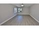 Spacious bedroom with wood-look flooring, ample natural light, and neutral paint at 1806 Wolf Laurel Dr, Sun City Center, FL 33573