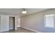 Empty bedroom with wood-look flooring, natural light, and a closet at 1806 Wolf Laurel Dr, Sun City Center, FL 33573