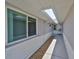 Exterior walkway of the home, featuring a skylight and neutral color scheme at 1806 Wolf Laurel Dr, Sun City Center, FL 33573