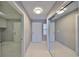Hallway featuring white walls, tile floors, and a sliding mirror door at 1806 Wolf Laurel Dr, Sun City Center, FL 33573