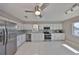 Bright kitchen with stainless steel appliances, granite countertops, white cabinetry, and a view of the water at 1806 Wolf Laurel Dr, Sun City Center, FL 33573
