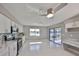 Modern eat-in kitchen with white cabinets, stainless steel appliances, and views of the outdoors at 1806 Wolf Laurel Dr, Sun City Center, FL 33573