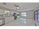 Bright kitchen featuring white cabinets, stainless steel appliances, granite counters and waterfront view at 1806 Wolf Laurel Dr, Sun City Center, FL 33573