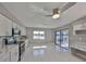 Bright kitchen with white cabinets, stainless steel appliances and tile floors, with a view of the lake at 1806 Wolf Laurel Dr, Sun City Center, FL 33573