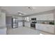 Modern kitchen with stainless steel appliances, white cabinets, and tile backsplash at 1806 Wolf Laurel Dr, Sun City Center, FL 33573