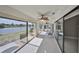 Enclosed lanai with tile floors, ceiling fans, and expansive windows with scenic lake views at 1806 Wolf Laurel Dr, Sun City Center, FL 33573