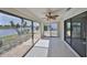 Enclosed lanai with tile floors, ceiling fan, and expansive windows with beautiful lake view at 1806 Wolf Laurel Dr, Sun City Center, FL 33573