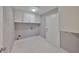 Bright laundry room featuring white cabinets and tile flooring, with utility connections ready at 1806 Wolf Laurel Dr, Sun City Center, FL 33573