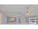 Open floorplan living room with a ceiling fan, window, and access to the backyard at 1806 Wolf Laurel Dr, Sun City Center, FL 33573