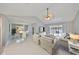 Bright and spacious living room with tile floors and an adjacent dining area at 1806 Wolf Laurel Dr, Sun City Center, FL 33573