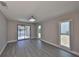 Bright living room featuring vinyl floors, natural light, and a view of the lanai at 1806 Wolf Laurel Dr, Sun City Center, FL 33573