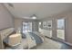 Inviting main bedroom showcasing water views, comfortable decor, and natural light from large windows and sliding glass doors at 1806 Wolf Laurel Dr, Sun City Center, FL 33573