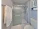 Modern shower enclosed with a frosted glass door and featuring white marble-style walls at 1806 Wolf Laurel Dr, Sun City Center, FL 33573