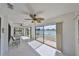 Bright sun room with large windows, tile flooring, and view to the lake at 1806 Wolf Laurel Dr, Sun City Center, FL 33573