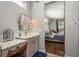 Bathroom sink and vanity with access to the main bedroom featuring hardwood floors at 182 E Canal Dr, Palm Harbor, FL 34684