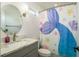 Bathroom with a round mirror and a mermaid themed shower curtain at 182 E Canal Dr, Palm Harbor, FL 34684