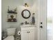 Nautical themed half bath featuring a round mirror, decorative shelves and charming accents at 182 E Canal Dr, Palm Harbor, FL 34684