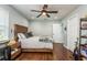 Bedroom featuring hardwood floors, a wooden bed, ceiling fan, and lots of natural light at 182 E Canal Dr, Palm Harbor, FL 34684