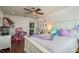 Bright bedroom featuring hardwood floors, a ceiling fan, and access to another bathroom at 182 E Canal Dr, Palm Harbor, FL 34684