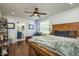 Bedroom featuring a wooden bed, hardwood floors, ceiling fan, and attached bathroom at 182 E Canal Dr, Palm Harbor, FL 34684