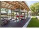 Covered boat dock featuring boat lift, wooden deck, and a well-maintained lawn at 182 E Canal Dr, Palm Harbor, FL 34684