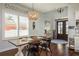 Elegant dining room with a large wooden table, stylish lighting, and natural light from the adjacent windows at 182 E Canal Dr, Palm Harbor, FL 34684