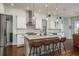 Bright kitchen boasts a center island with seating, stainless steel appliances, and pendant lighting at 182 E Canal Dr, Palm Harbor, FL 34684