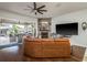 Spacious living room with stone fireplace and seamless transition to the covered lanai at 182 E Canal Dr, Palm Harbor, FL 34684