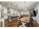 Open-concept kitchen and dining area, featuring granite countertops, stainless steel appliances, and a cozy fireplace at 182 E Canal Dr, Palm Harbor, FL 34684