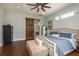 Spacious main bedroom with dark wood floors, large bed, and barn door to the bathroom at 182 E Canal Dr, Palm Harbor, FL 34684