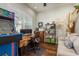 Bright home office featuring a custom desk, cozy seating area, and ample natural light at 182 E Canal Dr, Palm Harbor, FL 34684