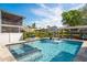 Stunning pool and spa with in-water seating and lush landscaping. Includes adjacent boat dock at 182 E Canal Dr, Palm Harbor, FL 34684