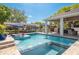 Stunning pool area with swim-up bar, integrated spa, and covered outdoor kitchen at 182 E Canal Dr, Palm Harbor, FL 34684