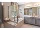 Luxurious bathroom with a soaking tub, separate shower, double vanity, and elegant tile work at 1880 Longliner Loop, Wesley Chapel, FL 33543