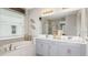 Bright bathroom with double vanity, large mirror, soaking tub and decorative wall art at 1880 Longliner Loop, Wesley Chapel, FL 33543