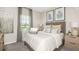 Serene bedroom featuring plush bedding, soft lighting, and a picturesque window view at 1880 Longliner Loop, Wesley Chapel, FL 33543