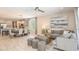 Open-concept living area with ample seating, stylish decor, and seamless connection to the kitchen and dining area at 1880 Longliner Loop, Wesley Chapel, FL 33543