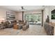 Cozy living room with stylish furniture, an open floor plan, and seamless indoor-outdoor flow to the lanai at 1880 Longliner Loop, Wesley Chapel, FL 33543