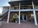 Apartment building exterior with covered balconies, stairs and multiple entry doors to units at 200 Country Club Dr # 1101, Largo, FL 33771