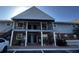 Two-story condo building featuring a brick facade, gray siding, and individual entryways at 200 Country Club Dr # 1101, Largo, FL 33771