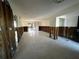 Spacious living room showing the studs, and tile floor with a sliding glass door at 200 Country Club Dr # 1101, Largo, FL 33771