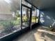 Enclosed porch overlooking a garden with palm trees and various greenery at 200 Country Club Dr # 1101, Largo, FL 33771