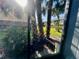 View of a garden with palm trees and various greenery from the enclosed porch at 200 Country Club Dr # 1101, Largo, FL 33771