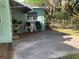 An outdoor patio with ample space and mature foliage is perfect for relaxation and entertaining at 2001 E Powhatan Ave, Tampa, FL 33610