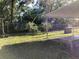Spacious backyard with grass, patio, and a chain-link fence for privacy at 2001 E Powhatan Ave, Tampa, FL 33610